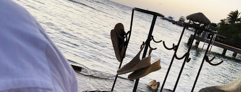 At the caribbean: Flying Fishbone Aruba dining with your feet in the sea with hooks for your slippers/flip flops!